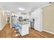 Modern kitchen with white cabinets, stainless steel appliances, and a stylish island with barstool seating at 827 Fraser Se St, Atlanta, GA 30315