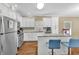 Bright kitchen features white cabinets, stainless steel appliances, and a convenient center island with seating at 827 Fraser Se St, Atlanta, GA 30315