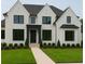 Stunning two-story home featuring a brick exterior, black trim, lush green lawn, and manicured landscaping at 2868 Octavia Cir, Marietta, GA 30062