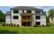 Beautiful backyard featuring a covered deck, lush green grass, dark trim, and ample space for outdoor living at 2868 Octavia Cir, Marietta, GA 30062