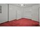 Neutral bedroom featuring bright white walls, red carpet, and a ceiling fan at 3524 Forest Downs Cv, Decatur, GA 30034