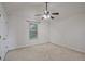 Neutral bedroom featuring bright white walls, tan carpet, and a ceiling fan at 3524 Forest Downs Cv, Decatur, GA 30034