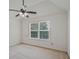 Bright bedroom featuring a large window and neutral carpet at 3524 Forest Downs Cv, Decatur, GA 30034