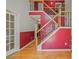 Inviting entryway with hardwood floors, featuring a staircase with decorative wrought iron spindles at 3524 Forest Downs Cv, Decatur, GA 30034