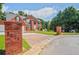 Charming two-story red brick home with a manicured front lawn and brick driveway at 3524 Forest Downs Cv, Decatur, GA 30034