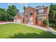 Charming two-story brick home with three car garage and large front lawn, surrounded by trees at 3524 Forest Downs Cv, Decatur, GA 30034