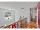 Upstairs hallway featuring a view to the front yard and a hardwood floor at 3524 Forest Downs Cv, Decatur, GA 30034