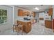 Eat-in kitchen featuring wood cabinets, a breakfast bar, and updated marble flooring at 3524 Forest Downs Cv, Decatur, GA 30034
