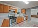 Well-equipped kitchen with light wood cabinets, stainless steel appliances, and an adjacent living area at 3524 Forest Downs Cv, Decatur, GA 30034
