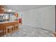 View of the eat-in kitchen featuring wood cabinets, breakfast bar, and updated marble flooring at 3524 Forest Downs Cv, Decatur, GA 30034