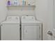 This laundry room features a new washer and dryer and shelving at 3524 Forest Downs Cv, Decatur, GA 30034