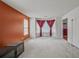 Spacious living room with carpet, featuring large windows with red curtains that provide natural light at 3524 Forest Downs Cv, Decatur, GA 30034