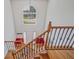 Open staircase featuring natural wood treads and unique wrought iron railings at 3524 Forest Downs Cv, Decatur, GA 30034