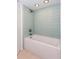 This bathroom has a bath tub and shower with bright blue wall tiles at 72 Sutton Pl, Avondale Estates, GA 30002