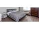 This bedroom features a plush bed, modern nightstand, and dark dresser at 72 Sutton Pl, Avondale Estates, GA 30002