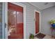 Close up of the condo entrance with a red door, light grey siding and a welcome mat at 72 Sutton Pl, Avondale Estates, GA 30002