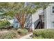 Light grey two-story condo featuring a well-manicured lawn and stairs leading to the upper level entrance at 72 Sutton Pl, Avondale Estates, GA 30002