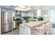 Bright kitchen with stainless steel appliances, breakfast bar, granite countertops, and tile backsplash at 72 Sutton Pl, Avondale Estates, GA 30002