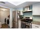 Kitchen with stainless steel appliances and laundry area at 72 Sutton Pl, Avondale Estates, GA 30002