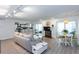 Open-concept living room with natural light, updated flooring, and a white-painted fireplace at 72 Sutton Pl, Avondale Estates, GA 30002