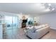 Bright open-concept living room with access to the kitchen and patio with updated flooring and a fireplace at 72 Sutton Pl, Avondale Estates, GA 30002