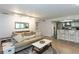 Bright open-concept living room featuring updated flooring, a kitchen bar, and modern decor at 72 Sutton Pl, Avondale Estates, GA 30002