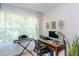 Office with wooden desk, computer, keyboard, and natural light at 72 Sutton Pl, Avondale Estates, GA 30002