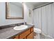 Bathroom featuring vanity, toilet, mirror, and shower with a black and white tiled floor at 1080 Rackley Nw Way, Kennesaw, GA 30144