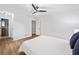 A bright bedroom with clean white walls, ceiling fan and wood-look flooring at 1080 Rackley Nw Way, Kennesaw, GA 30144