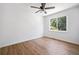 A bright bedroom with wood-look floors, ceiling fan and large window with green view at 1080 Rackley Nw Way, Kennesaw, GA 30144