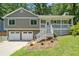 Charming home featuring a welcoming front porch, two-car garage and mature trees at 1080 Rackley Nw Way, Kennesaw, GA 30144