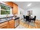 Bright kitchen with stainless appliances, granite counters, and a dining area with French doors at 1080 Rackley Nw Way, Kennesaw, GA 30144