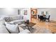 Open-concept living space with hardwood floors seamlessly connecting the living room to the kitchen and dining area at 1080 Rackley Nw Way, Kennesaw, GA 30144