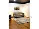 Inviting living room featuring a comfortable sofa, stylish decor, and wood flooring at 1080 Rackley Nw Way, Kennesaw, GA 30144