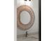 Close-up of a modern bathroom sink, faucet, and decorative circular mirror at 2325 Mason Dr # D22, Atlanta, GA 30316