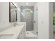Bathroom featuring a double sink vanity, a glass shower, and a window at 2325 Mason Dr # D22, Atlanta, GA 30316