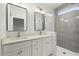 Bathroom featuring double sinks, white cabinets, and a glass shower with gray subway tile at 2325 Mason Dr # D22, Atlanta, GA 30316