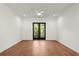 Bright bedroom featuring hardwood floors and access to a private balcony with a view at 2325 Mason Dr # D22, Atlanta, GA 30316