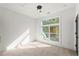 Bright bedroom with large windows offering a scenic outdoor view and modern lighting at 2325 Mason Dr # D22, Atlanta, GA 30316