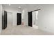 Bright bedroom featuring three doorways, one with a barn door leading to the bathroom at 2325 Mason Dr # D22, Atlanta, GA 30316