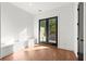 Bedroom with hardwood floors, recessed lighting, and doors leading to a balcony at 2325 Mason Dr # D22, Atlanta, GA 30316