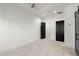 A bright bedroom with white walls, a ceiling fan, and two dark-colored doorways at 2325 Mason Dr # D22, Atlanta, GA 30316