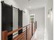 Second story hallway with sliding barn doors, hardwood floors, and modern lighting at 2325 Mason Dr # D22, Atlanta, GA 30316