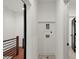 Upstairs hallway features a laundry hookup, wood floors, and a modern metal railing at 2325 Mason Dr # D22, Atlanta, GA 30316