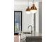 Close-up of a kitchen island with a sink, faucet, and pendant lighting at 2325 Mason Dr # D22, Atlanta, GA 30316