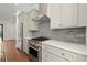 Modern kitchen with stainless steel appliances, light gray cabinets and countertops, and tile backsplash at 2325 Mason Dr # D22, Atlanta, GA 30316