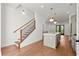 Open-concept kitchen and staircase with hardwood floors and modern lighting at 2325 Mason Dr # D22, Atlanta, GA 30316