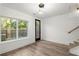Open living space with hardwood floors, large windows, a glass door, and modern pendant lighting at 2325 Mason Dr # D22, Atlanta, GA 30316
