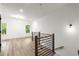 Loft space with wood floors, modern railings, and bright natural light from windows at 2325 Mason Dr # D22, Atlanta, GA 30316