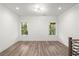 Bright second-story loft area with wood floors and natural light from large windows at 2325 Mason Dr # D22, Atlanta, GA 30316